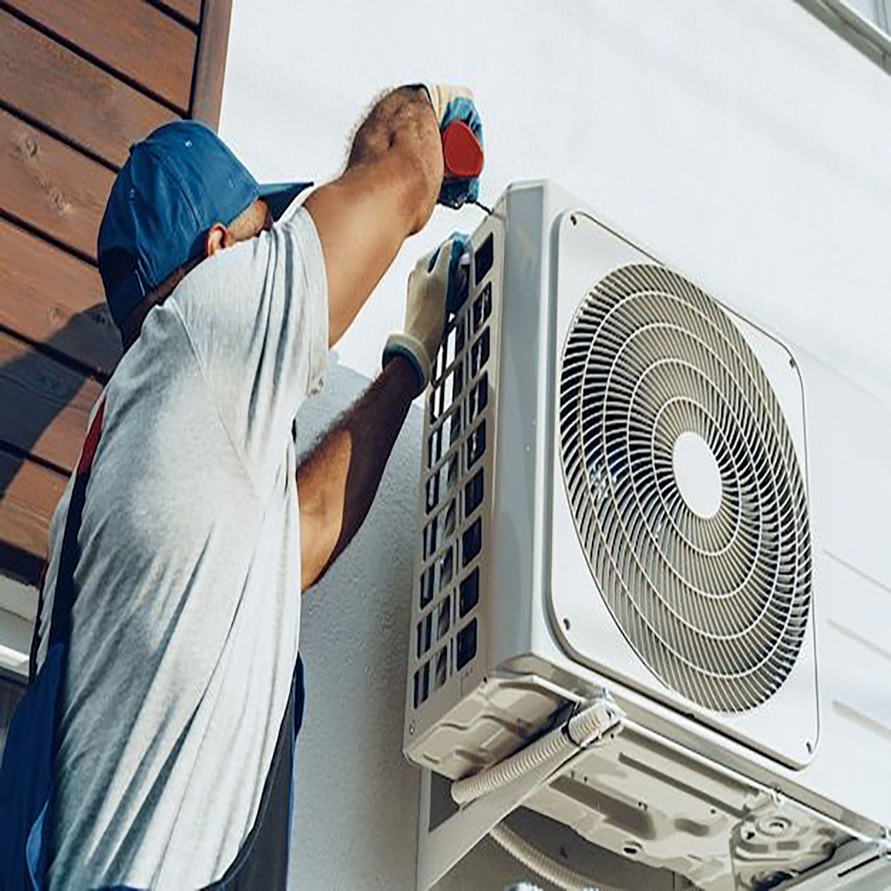 Repairman in uniform installing the outside unit of air conditioner _ Premium Photo