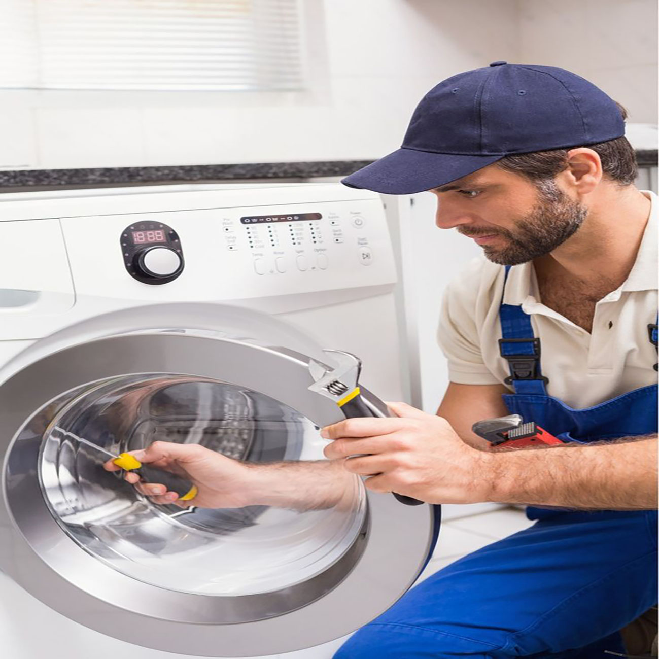 Technician Repairing Washing Machine